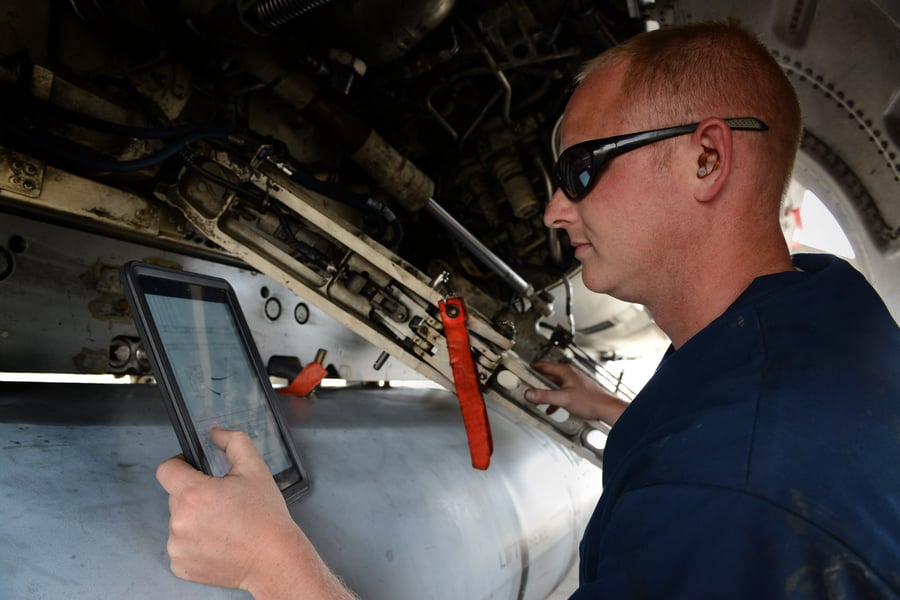Airplane mechanic using an iPad