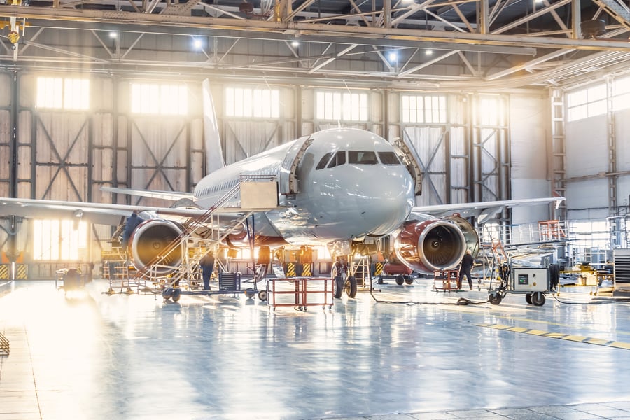 The inside the aviation hangar and mechanic working