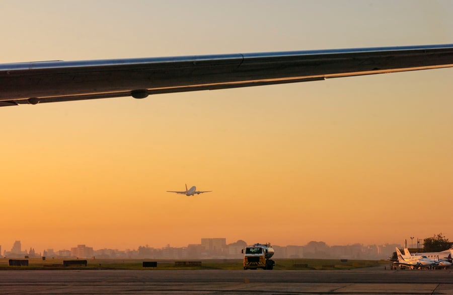 Airplane taking off in the late afternoon with sunset