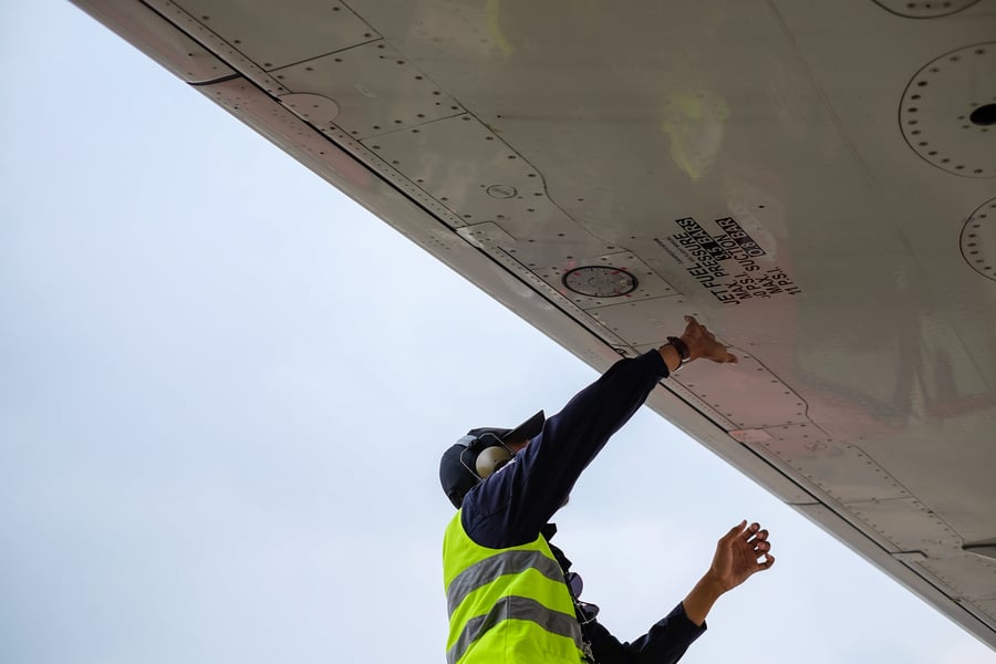 Source One Spares Understanding MSG-3 Aviation Maintenance Guy Inspecting Airplane Wing