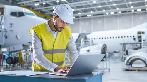 Aircraft engineer using laptop 